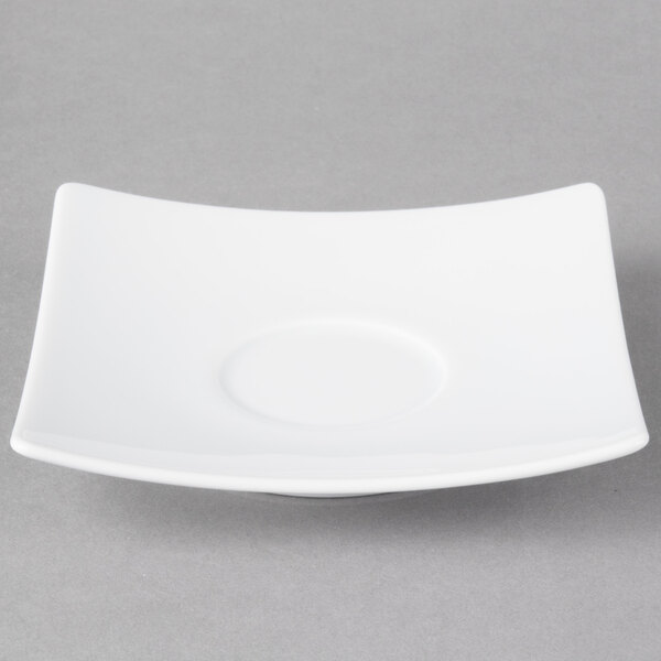 A white square Schonwald porcelain saucer with a circle in the middle.