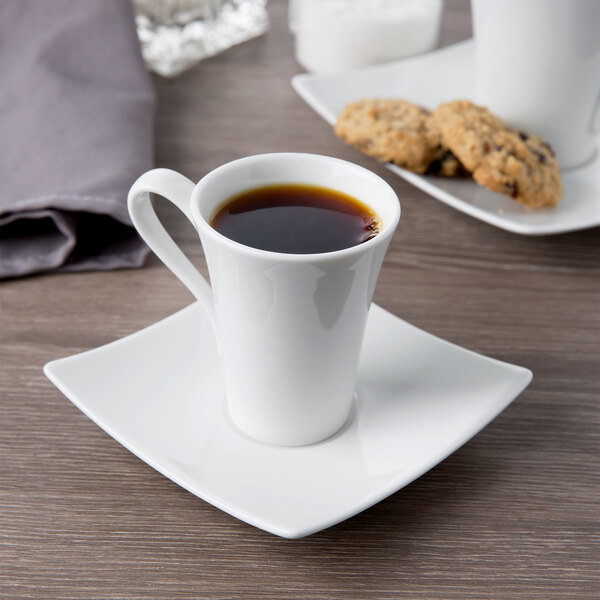 A Schonwald white porcelain saucer with a cup of coffee and cookies on it.