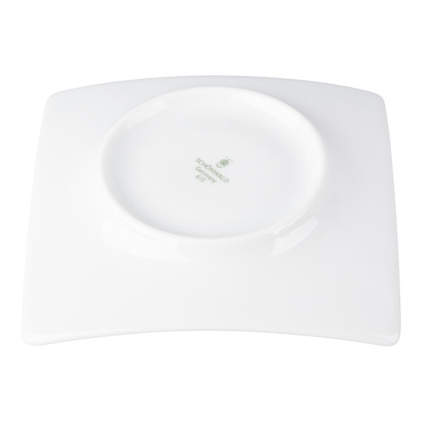 A white, square-shaped porcelain saucer with a circular indentation in the center, viewed from above.