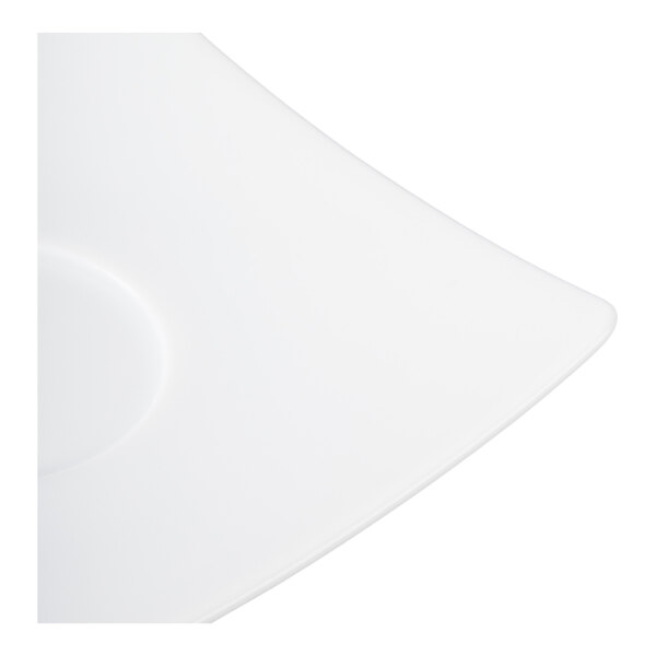 A close-up view of a white, square-shaped porcelain saucer with smooth, rounded edges.