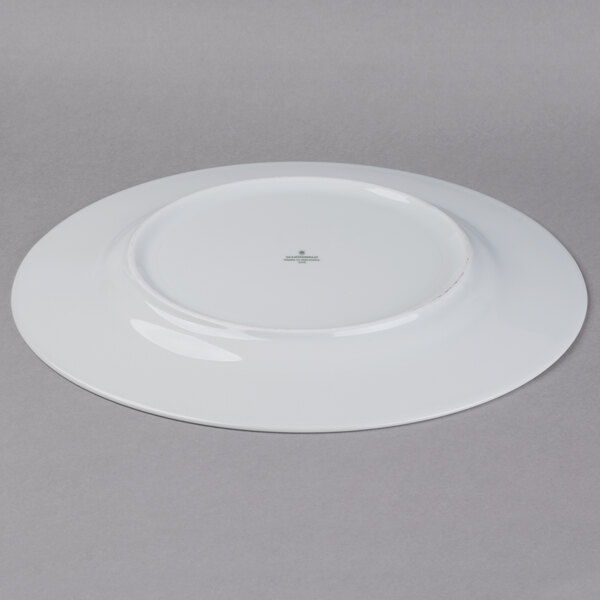 A white Schonwald porcelain plate with a small hole in the middle.