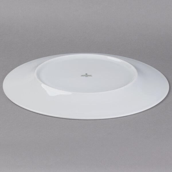 A Schonwald white porcelain plate with a green star design.