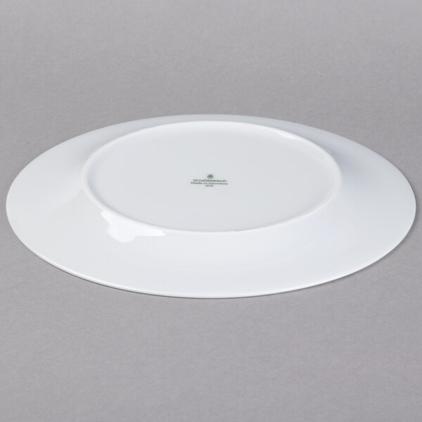 A Schonwald white porcelain plate with a cross on it.