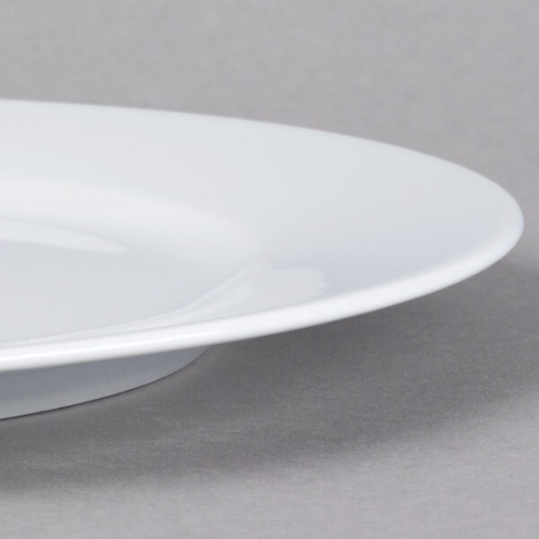 A close up of a Schonwald white porcelain plate with a rim.