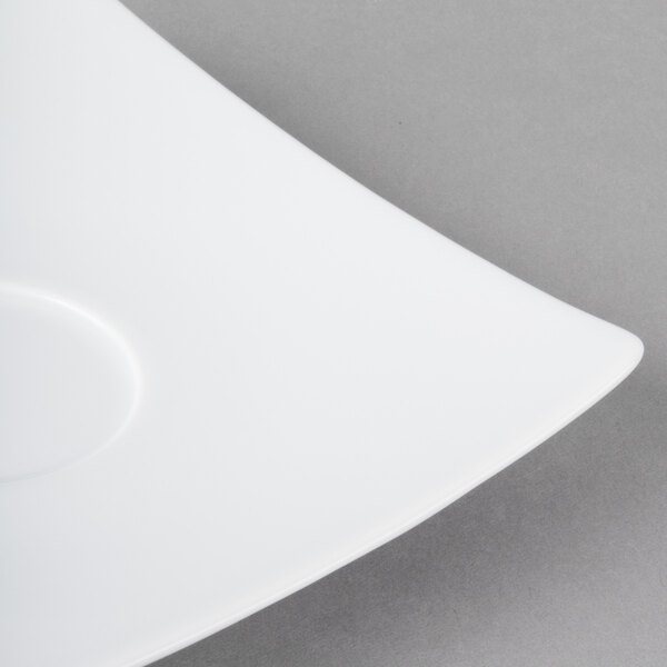 A close-up of a Schonwald white porcelain saucer with a curved edge.