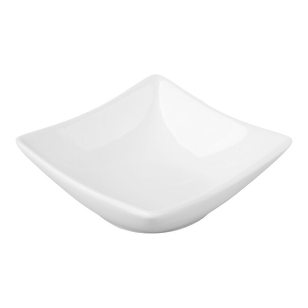 A small, white, square porcelain sauce cup.