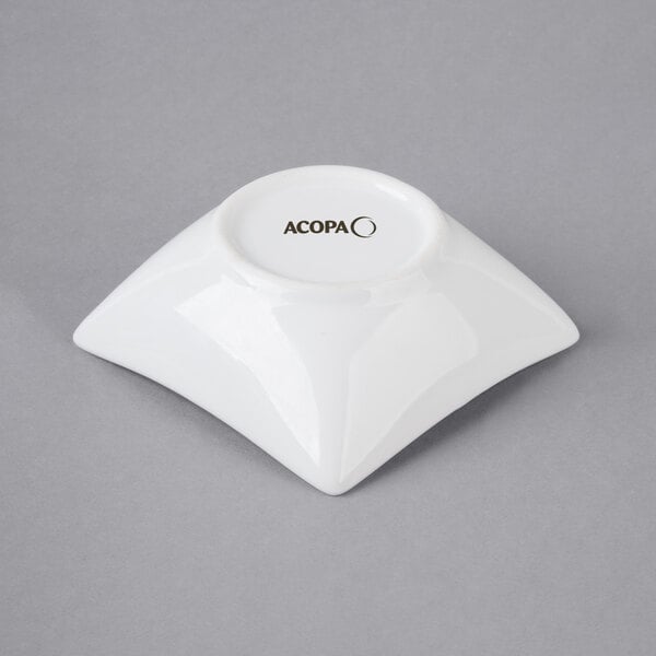 A white square Acopa porcelain sauce cup.