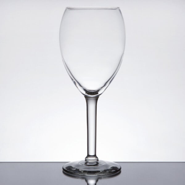 A clear Libbey tall wine glass with a stem on a table.