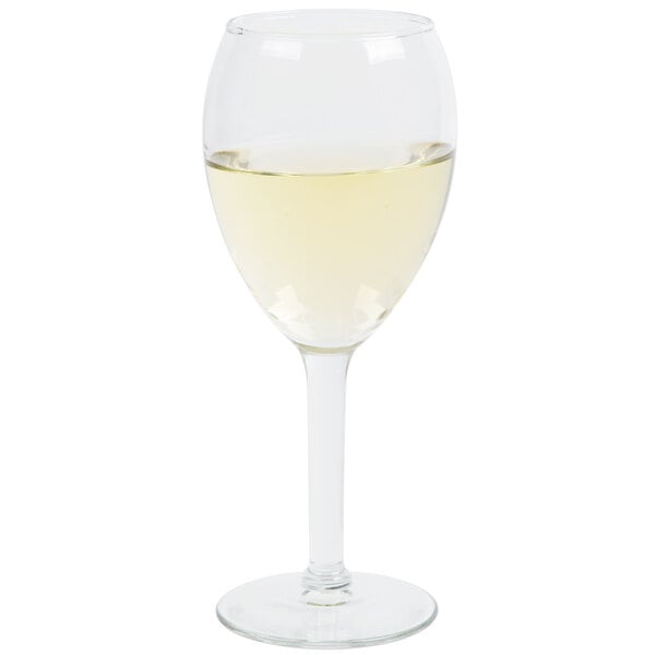 A close-up of a Libbey tall wine glass filled with white wine.