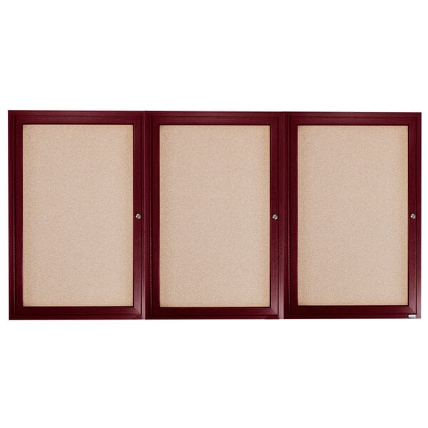 Three wooden framed bulletin boards with three doors, each with a cork board inside.
