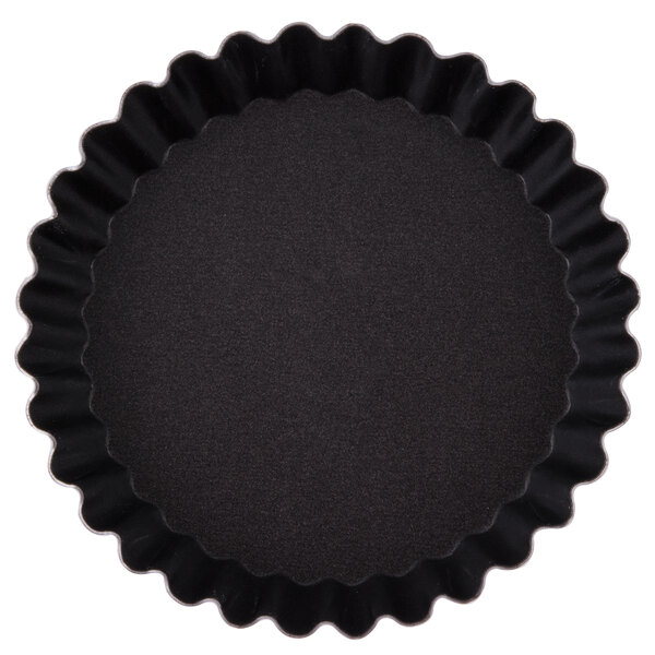 A black fluted Matfer Bourgeat tartlet pan.