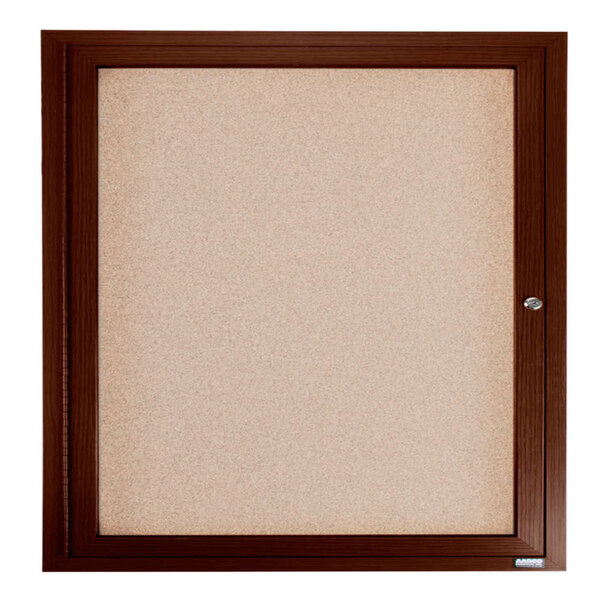 A brown framed enclosed bulletin board with a cork background.