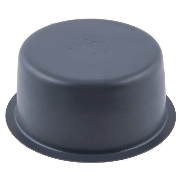 A black steel round ramekin mold with a round base.