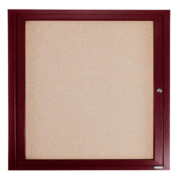 A cherry-framed enclosed cork bulletin board.