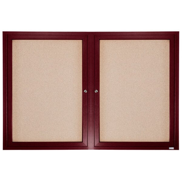 A cherry-framed enclosed bulletin board with cork inside.