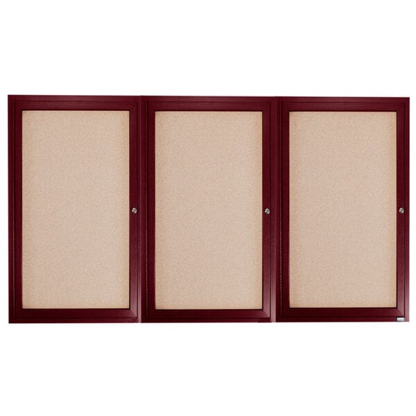 Three wooden framed bulletin boards with cherry doors.