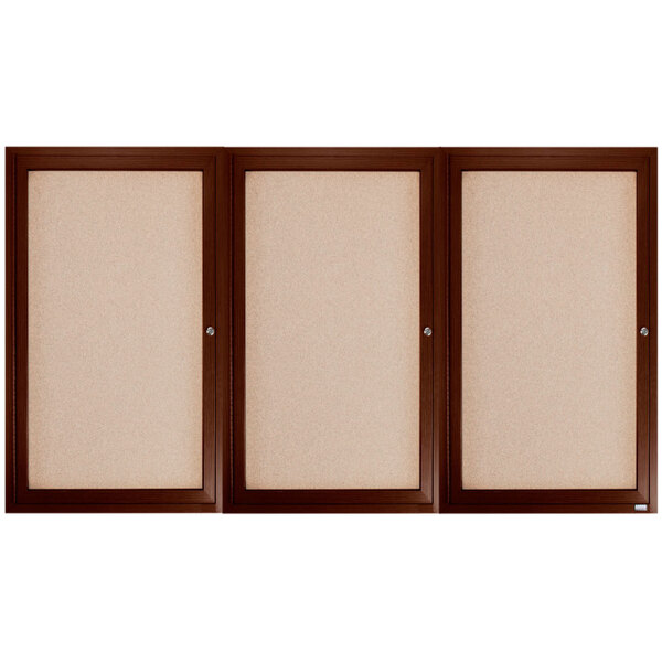 A white background with three brown framed bulletin doors.