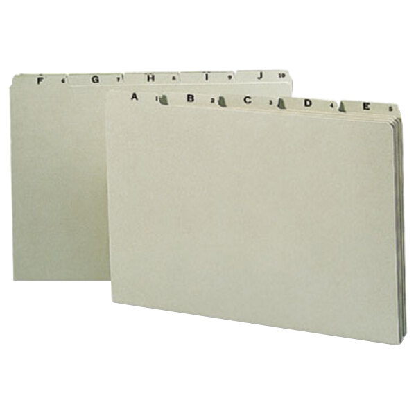 Two white Smead file folders with green alphabetical tabs and lettering on them.