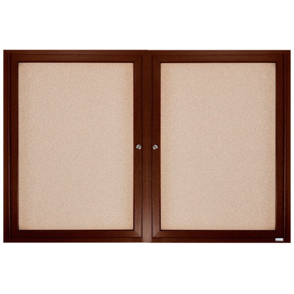 A brown wooden framed enclosed bulletin board with cork inside.