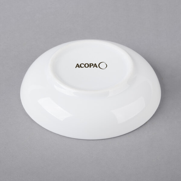 A white Acopa porcelain sauce cup with black text on it.