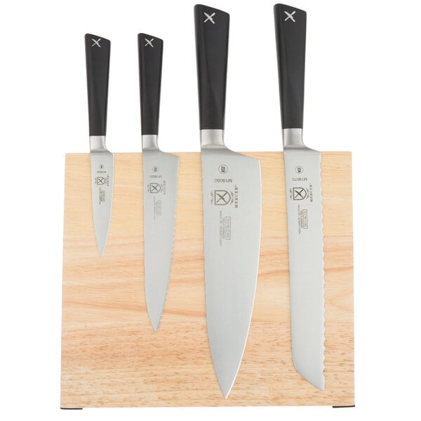 A Mercer Culinary Z&#252;M&#174; knife set on a wooden block.