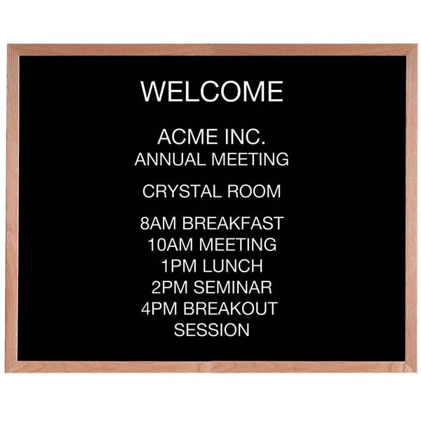An Aarco black felt board with white text that says "Acme Inc Annual Meeting"