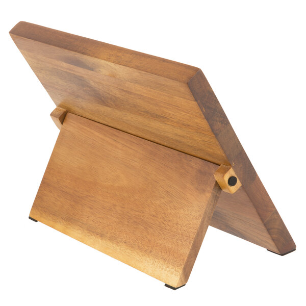 A Mercer Culinary ZüM® Acacia magnetic board and knife set on a wooden stand.