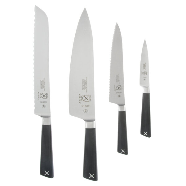 A group of Mercer Culinary ZüM knives with black handles on a white rectangular board.