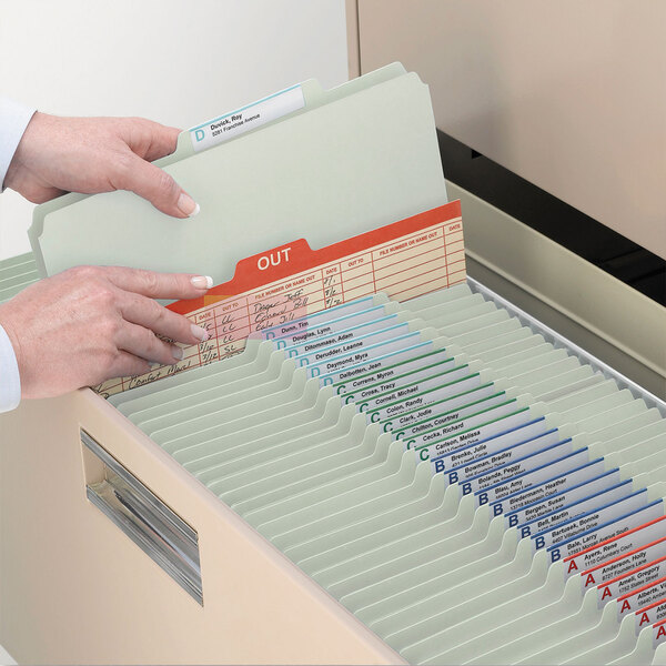 A person's hands opening a file drawer filled with Smead letter size classification folders.