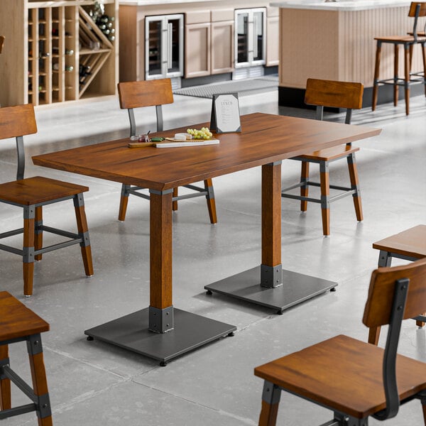 A rectangular solid wood live edge table with a rustic walnut finish and industrial metal base, surrounded by matching wooden chairs in a modern dining setting.