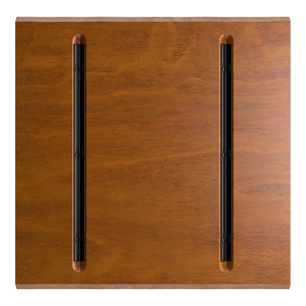 A square wooden surface with a rustic walnut finish, featuring two parallel black metal strips running vertically.