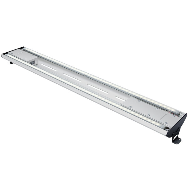 A long, rectangular curved metal light fixture with warm lighting.