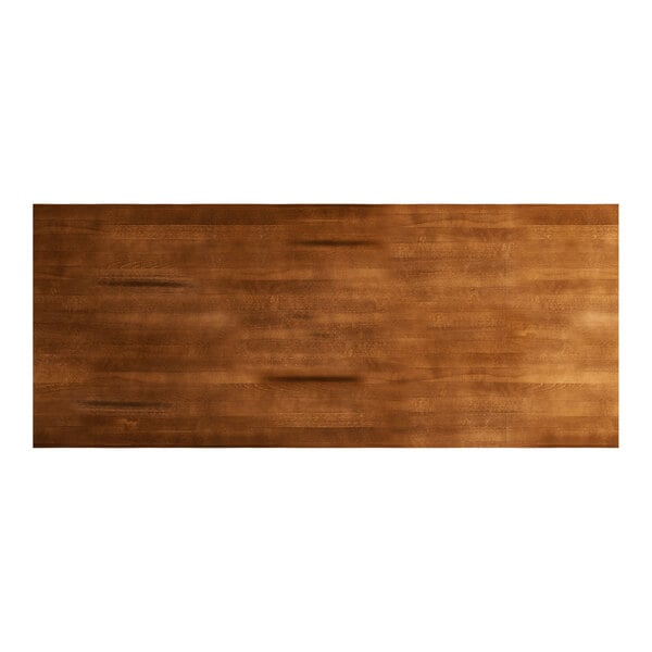 A brown rectangular wood surface with a live edge and rustic finish.