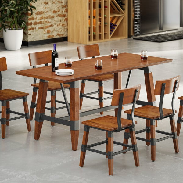A rectangular wooden dining table with a live edge design and six matching chairs, featuring a rustic walnut finish and metal accents, set with wine glasses, a wine bottle, and plates.