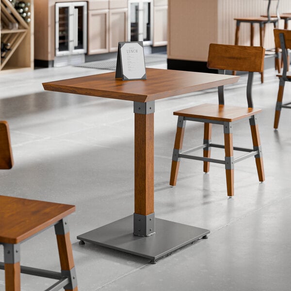 A Lancaster Table & Seating live edge table top with chairs in a restaurant.