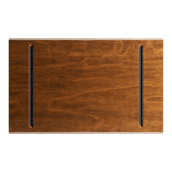 A Lancaster Table & Seating rectangular wood table top with a live edge and rustic walnut finish.