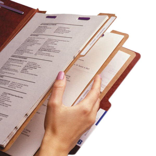 A hand holding a Smead SafeSHIELD file folder with papers.