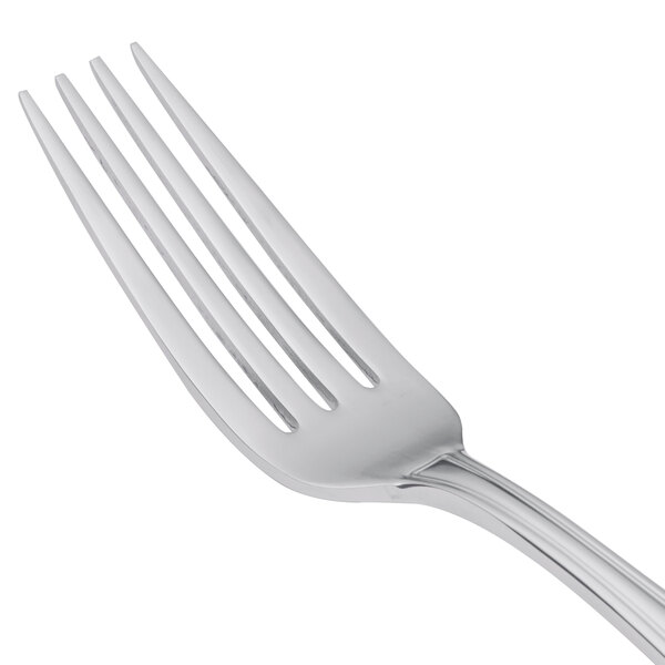 A close-up of a Libbey stainless steel dinner fork with a silver handle.