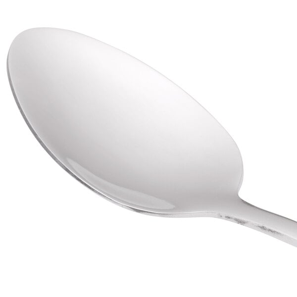 A World Tableware stainless steel teaspoon with a white handle.