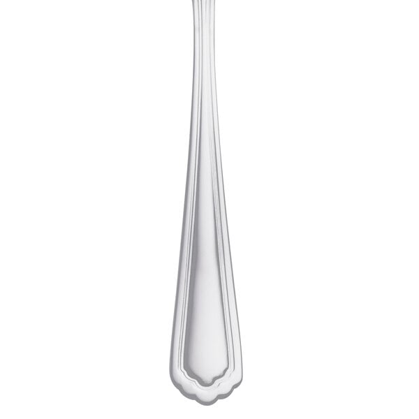 A Libbey Cortland stainless steel teaspoon with a white handle.