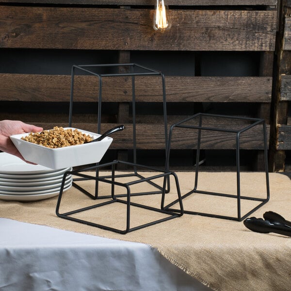 A person using a Libbey Versa Riser to hold a bowl of food.