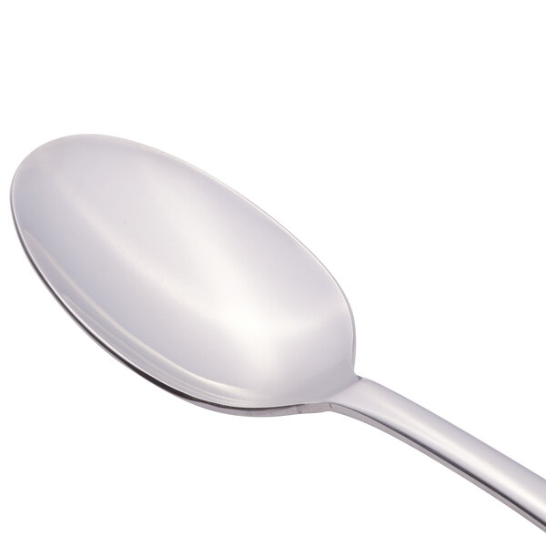 A Libbey stainless steel serving spoon with a silver handle.