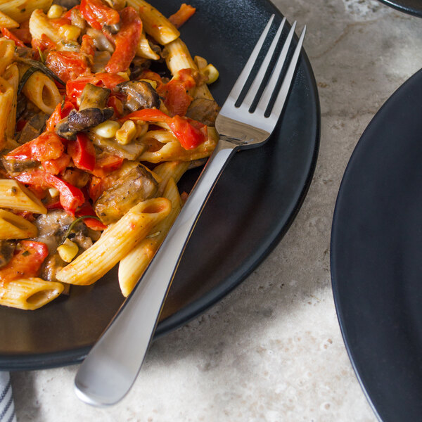 A plate of pasta with vegetables and a Libbey stainless steel dinner fork.