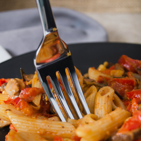 A Libbey stainless steel dinner fork in a plate of pasta.