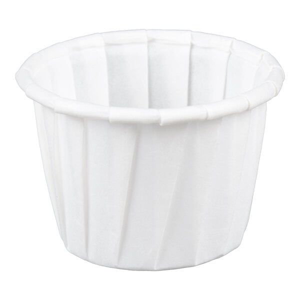 A small white paper souffle or portion cup.