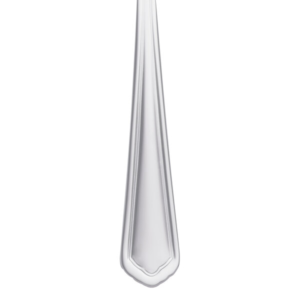A Libbey stainless steel salad fork with a white handle.
