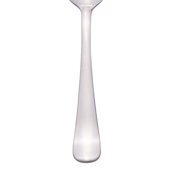 A Libbey stainless steel teaspoon with a white handle.