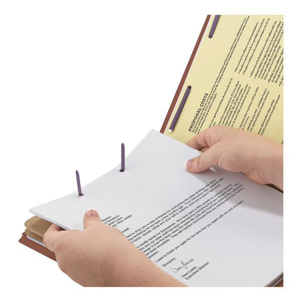 A person holding a Smead SafeSHIELD legal size classification file.