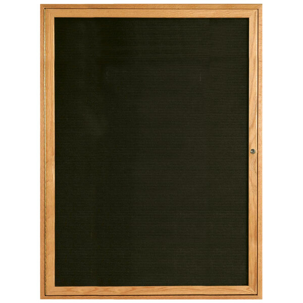 An Aarco black felt message board with a wooden frame.