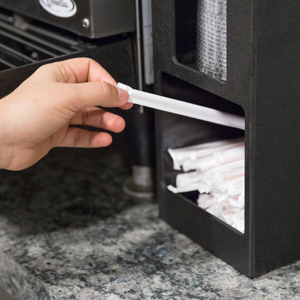 A person using a Vollrath black countertop lid organizer to get a straw.